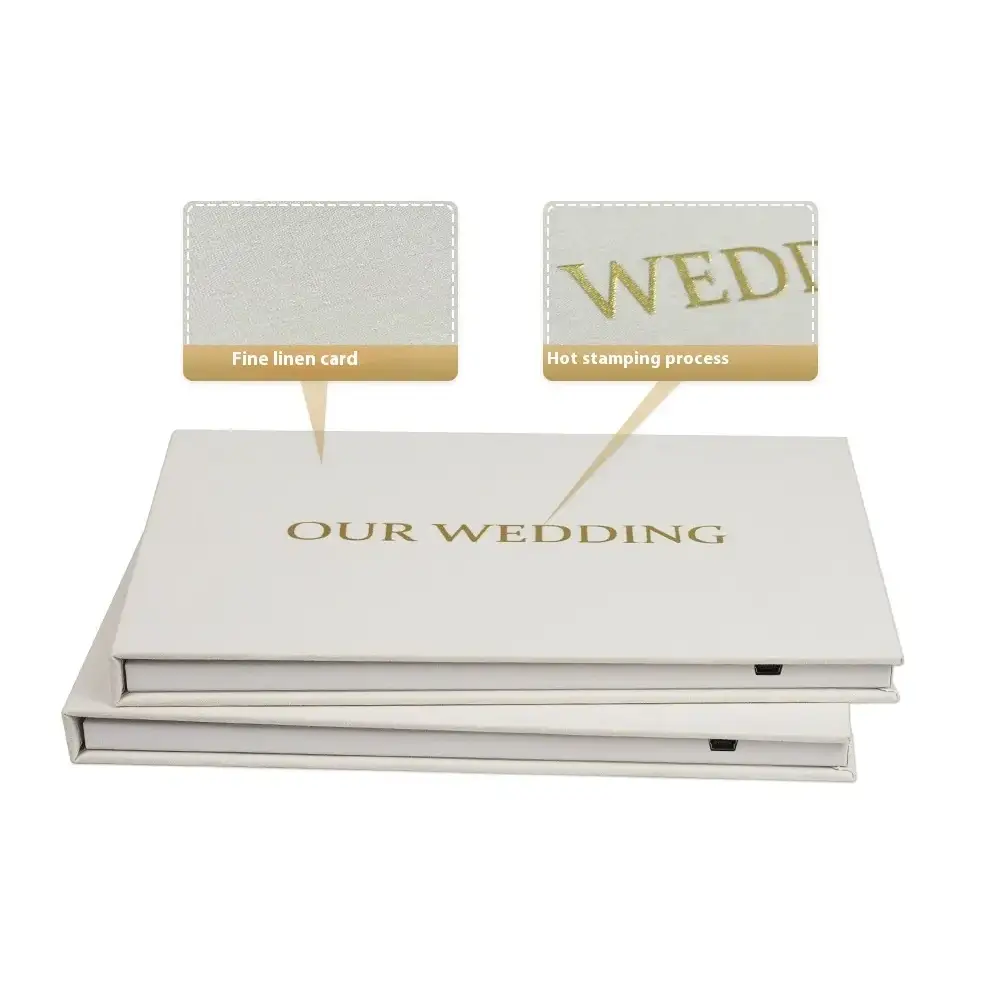 White wedding album with gold hot-stamped ’our wedding’ text on a fine linen card cover.