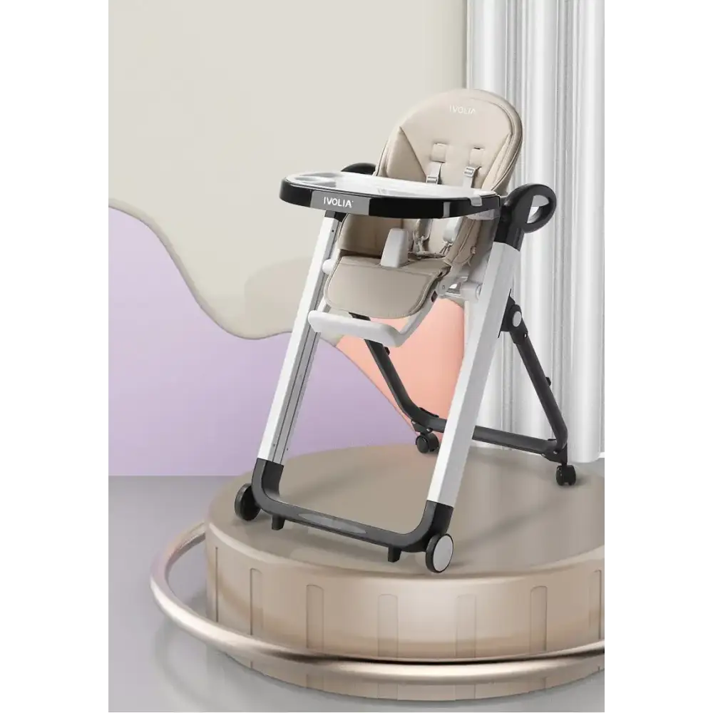 Beige and black ivolia baby high chair with a sleek, modern design featuring adjustable legs and wheels.