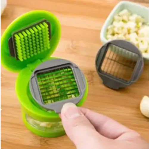 Green and gray garlic press with a grid-style cutting mechanism.