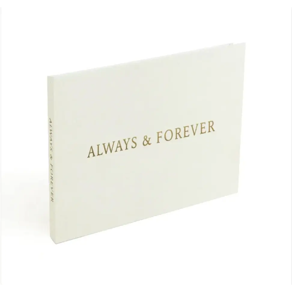 A cream-colored keepsake album with ’always & forever’ embossed in gold lettering on the cover.