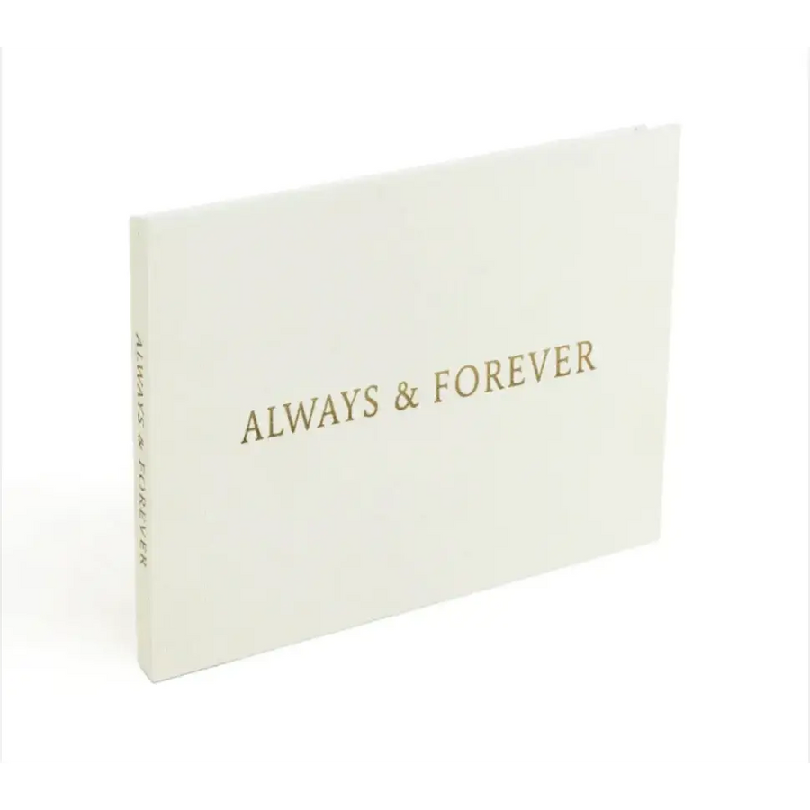 A minimalist white photo album with gold foil lettering that reads ’always & forever’ on the cover.