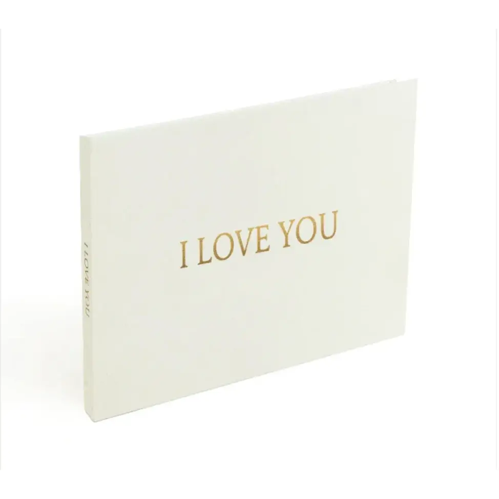 White ’i love you’ greeting book with gold foil lettering.