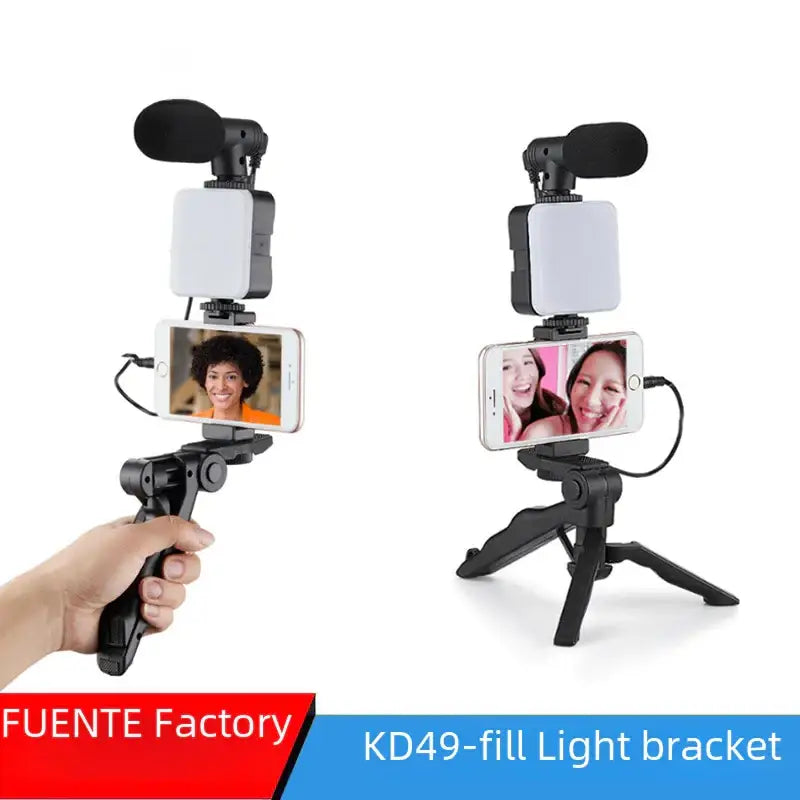 Black selfie stick with attached phone, led light panel, and microphone for video recording.