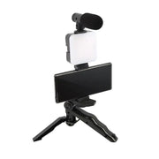 Black tripod-mounted smartphone video setup with integrated led light and microphone