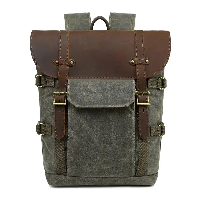 A rugged olive green canvas backpack with brown leather accents and brass hardware.