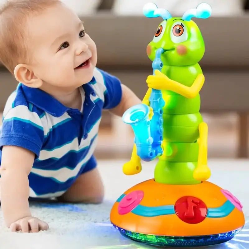 A bright green caterpillar-shaped toy with yellow limbs and blue antennae, holding a translucent blue saxophone, standing on an orange base adorned with pink and red buttons.