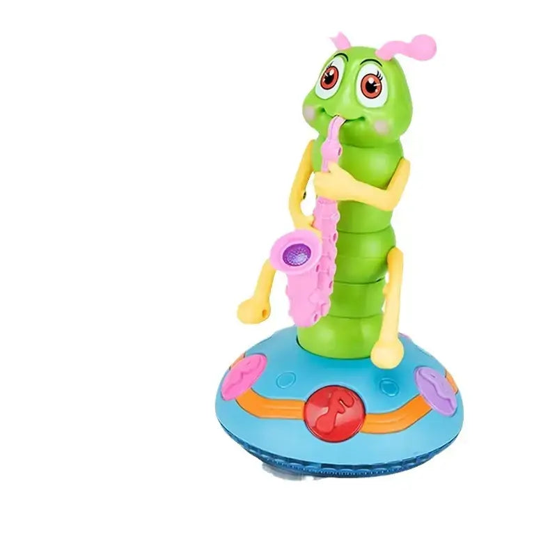 A green plastic caterpillar toy with pink antennae and yellow limbs, holding a pink saxophone, standing on a blue circular base adorned with colorful buttons.