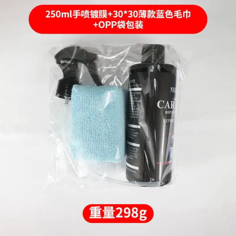 Black spray bottle with white text labeling it as ’car repair’ and a matching black pump nozzle, packaged alongside a light blue microfiber cloth in clear plastic.
