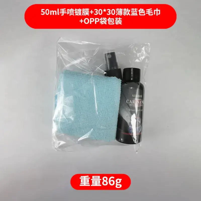 Blue microfiber cloth and black spray bottle in clear plastic packaging