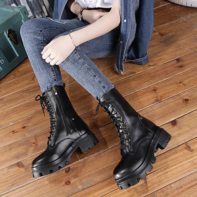 Black leather combat boots with thick soles and laces.