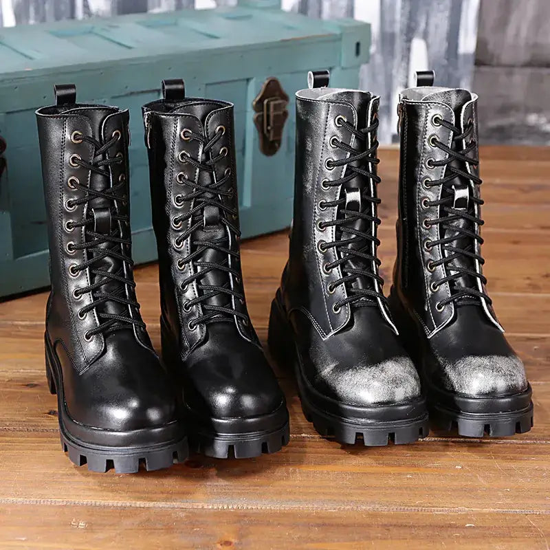 Black leather combat boots with laces and chunky soles.