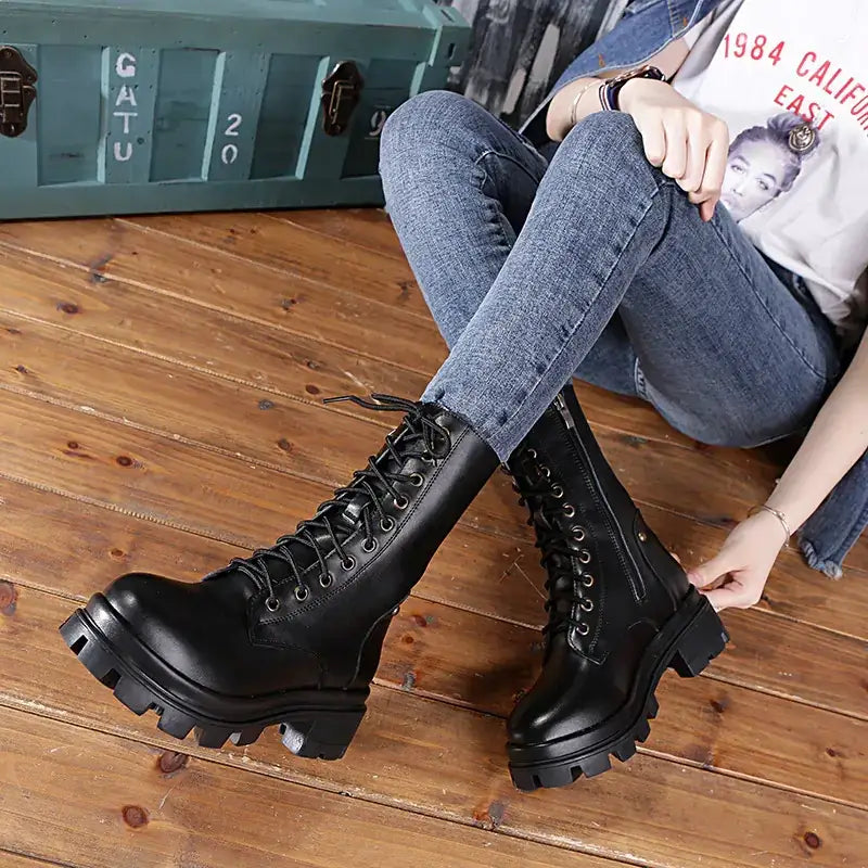 Black leather combat boots with thick soles and laces.