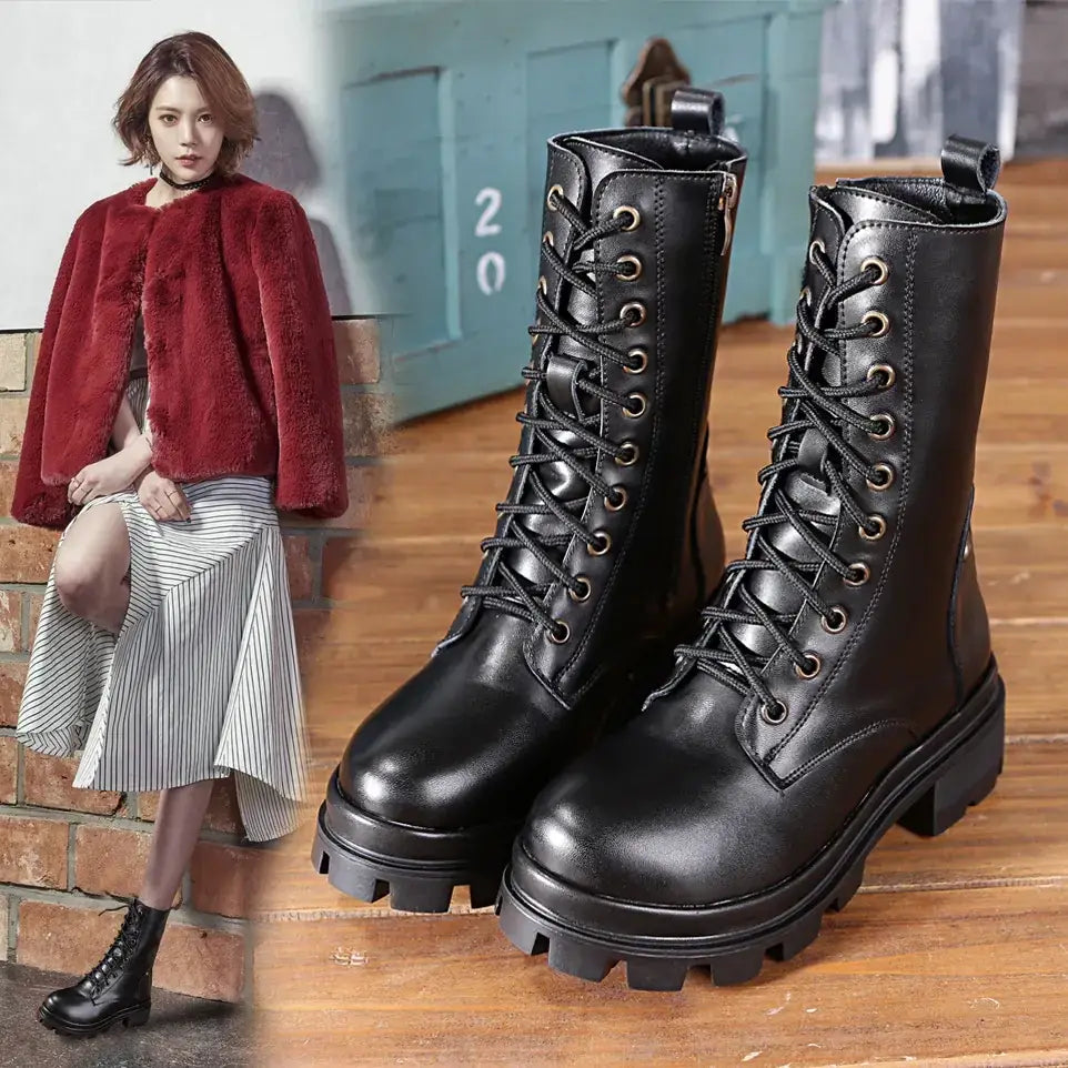 Black leather lace-up combat boots with a chunky, textured sole.