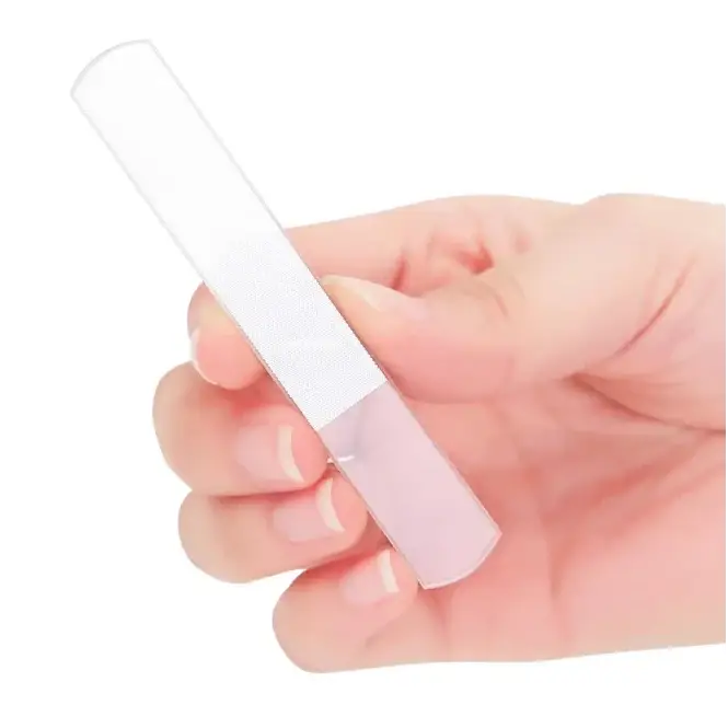 Transparent plastic nail file with a white textured grip section.