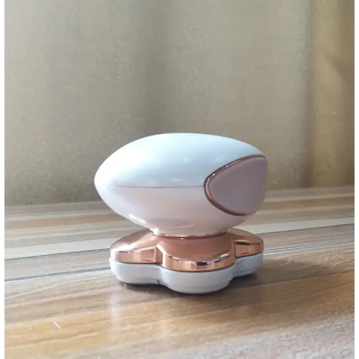 A sleek, oval-shaped electric razor with a white and rose gold finish.