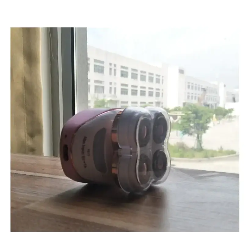 A sleek, rose gold and silver electric rotary shaver with four circular cutting heads.