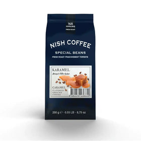 Nish coffee special beans caramel flavored ground coffee in a dark blue bag.