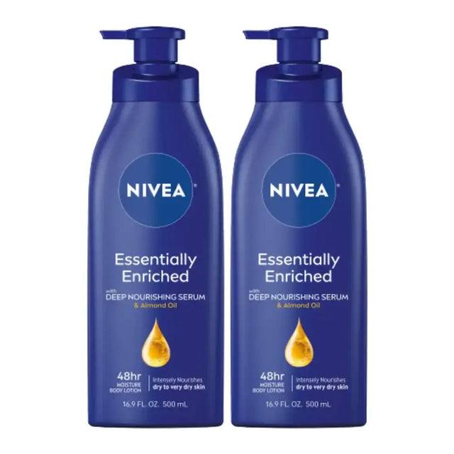 Two identical dark blue nivea essentially enriched body lotions with pump dispensers, each labeled as containing 500 ml of deep nourishing serum and almond oil.