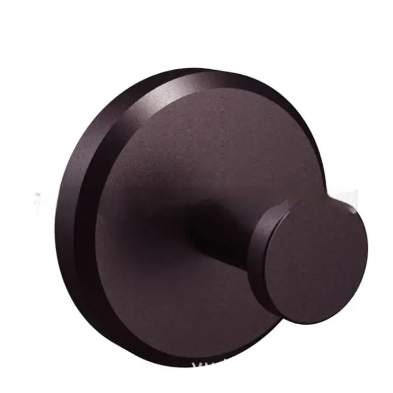 Dark bronze-colored, minimalist wall-mounted hook with a matte finish and circular design.