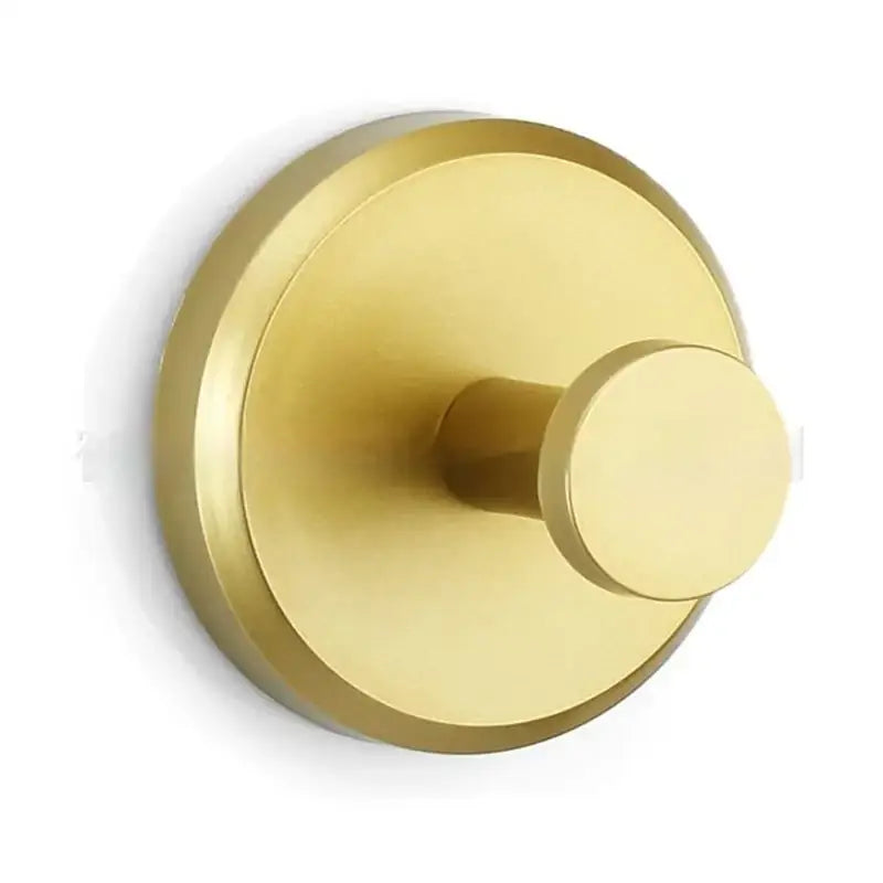 Brass-finished circular wall-mounted hook with a sleek, minimalist design.