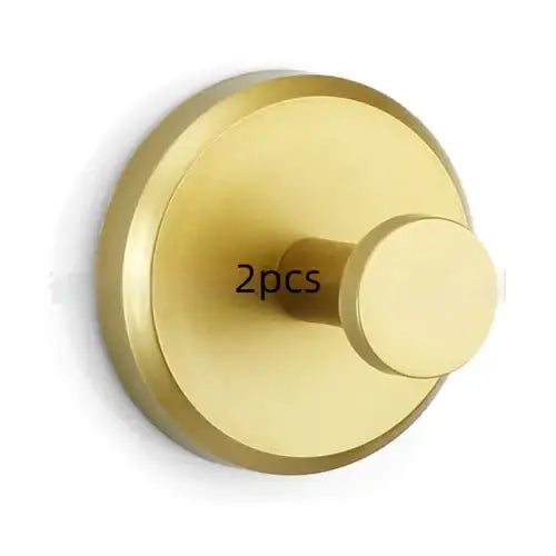 Brass-finished circular wall hook with a sleek, minimalist design.
