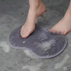 Gray silicone foot massage pad with dense, flexible bristles for soaking feet in water.