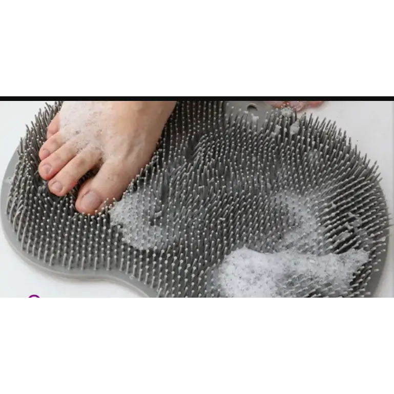 Gray silicone foot scrubber with dense, rounded bristles and a contoured shape for pedicure use.