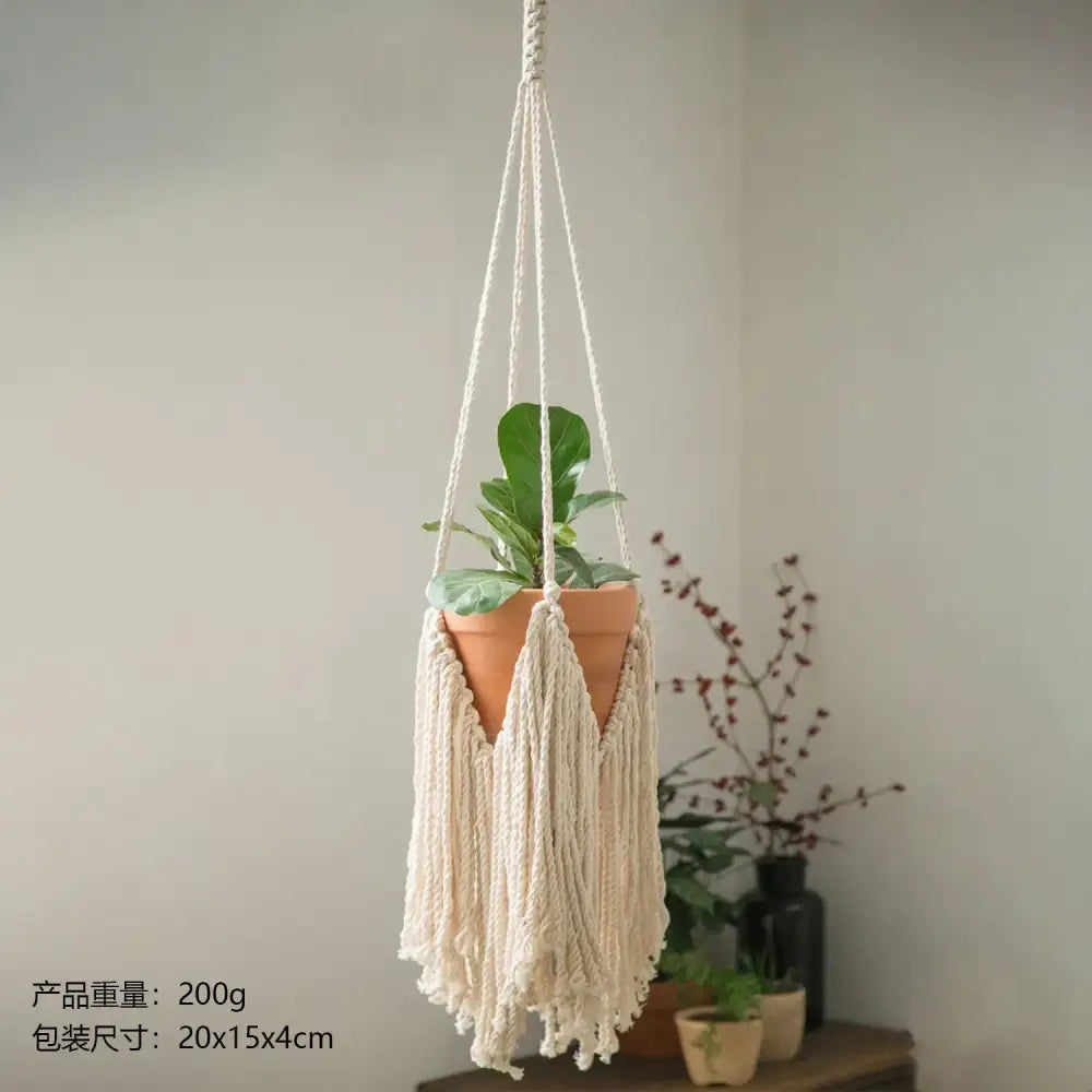 Cream-colored macrame hanging plant hanger with a terracotta pot suspended from its woven cords.
