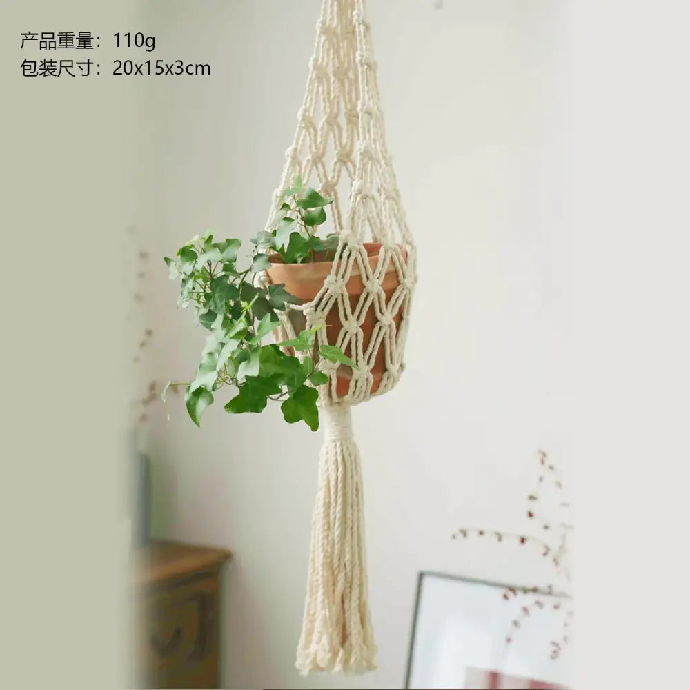 Cream-colored macrame plant hanger with a terracotta pot and trailing green ivy.