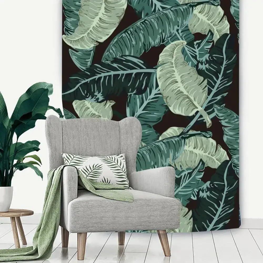 Gray wingback armchair with wooden legs and a green throw blanket draped over the side