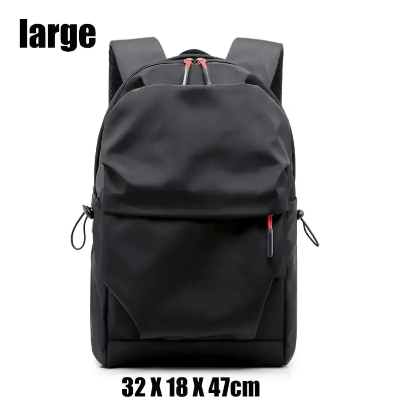 Black nylon backpack with red zipper pulls and side drawstrings.