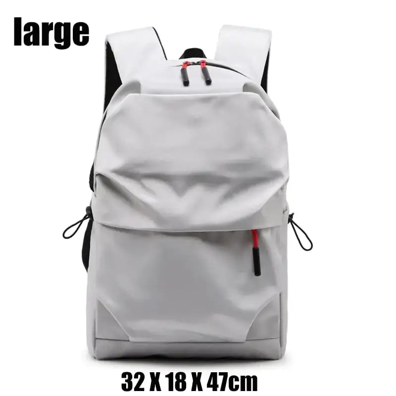Gray backpack with black and red accents, featuring a sleek, modern design.