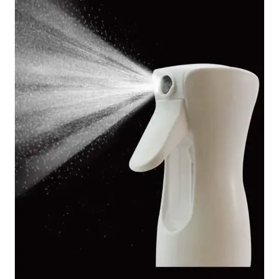 White plastic spray bottle with a trigger mechanism, emitting a fine mist against a black background.