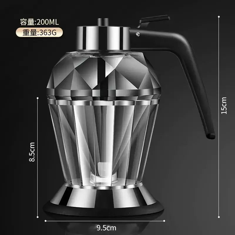 A sleek, faceted glass oil dispenser with a black handle and metallic accents.