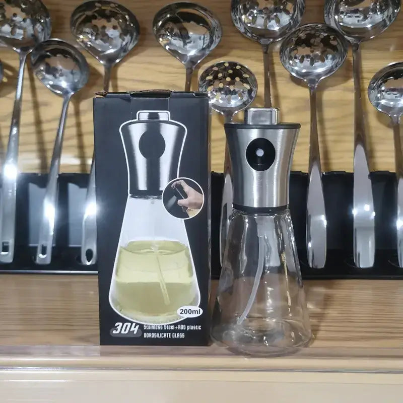 A sleek 200ml oil and vinegar dispenser with a stainless steel top, clear borosilicate glass body, and an integrated pump mechanism.