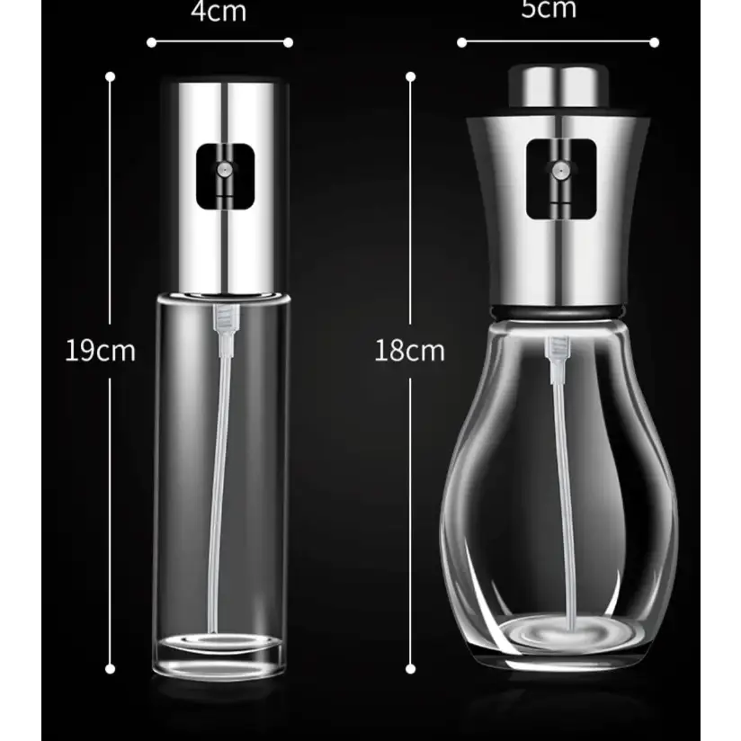 Two sleek, transparent glass spray bottles with polished stainless steel nozzles and caps.