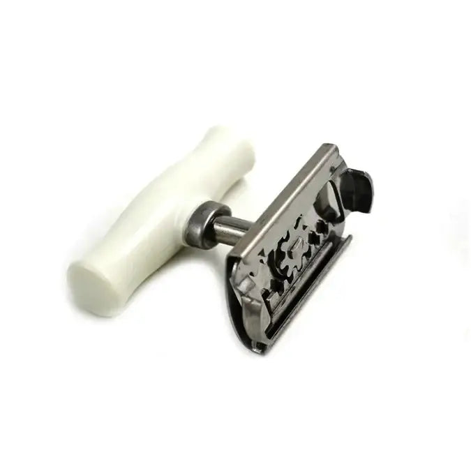 A classic safety razor with a white, smooth handle and a metallic head featuring an ornate gear-like design.