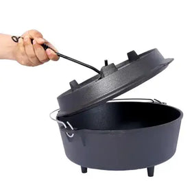 Black cast iron dutch oven with a matching lid and sturdy handles.