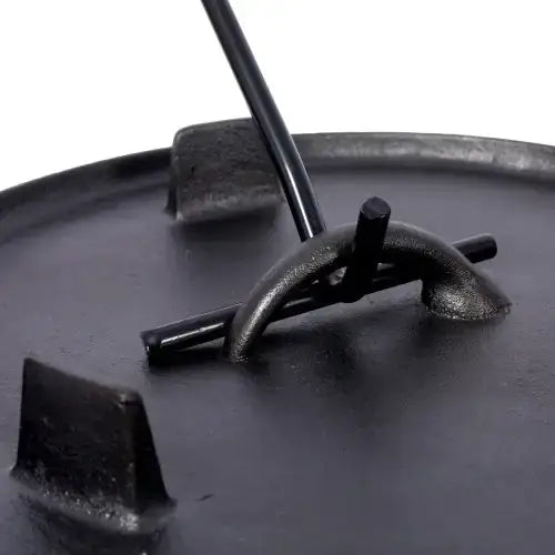 Black cast iron pot lid with a central handle and two side lugs.