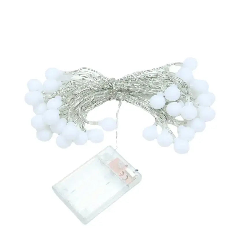 White spherical led string lights with a silver wire and clear battery pack.