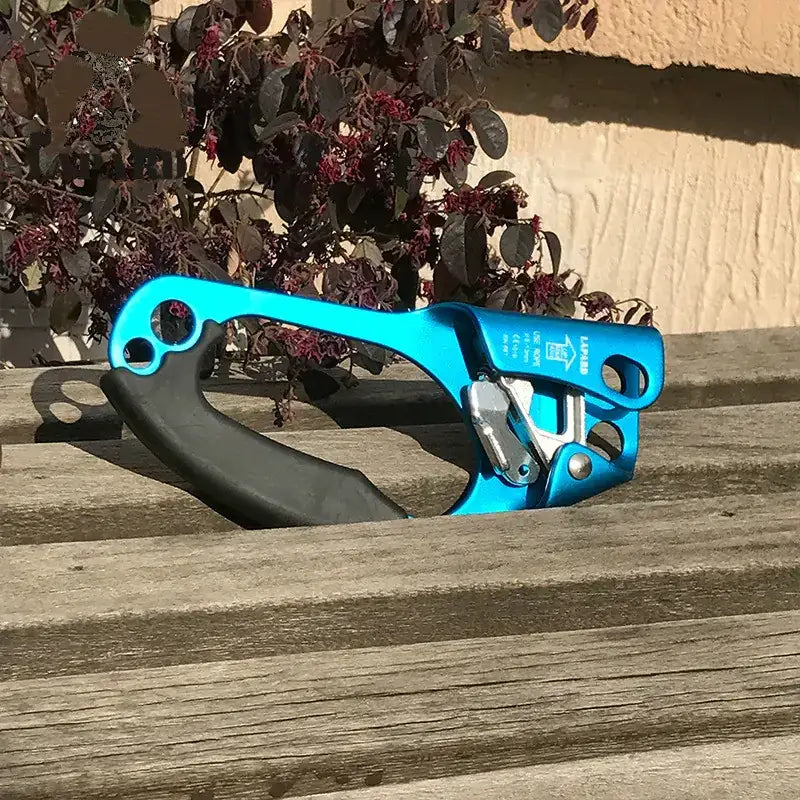 Bright blue aluminum climbing device with a black rubber grip and silver metal mechanism.