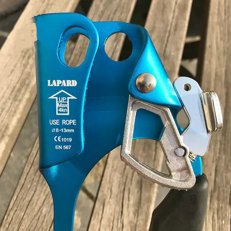 Blue lapard climbing device with a metallic trigger mechanism and black grip.