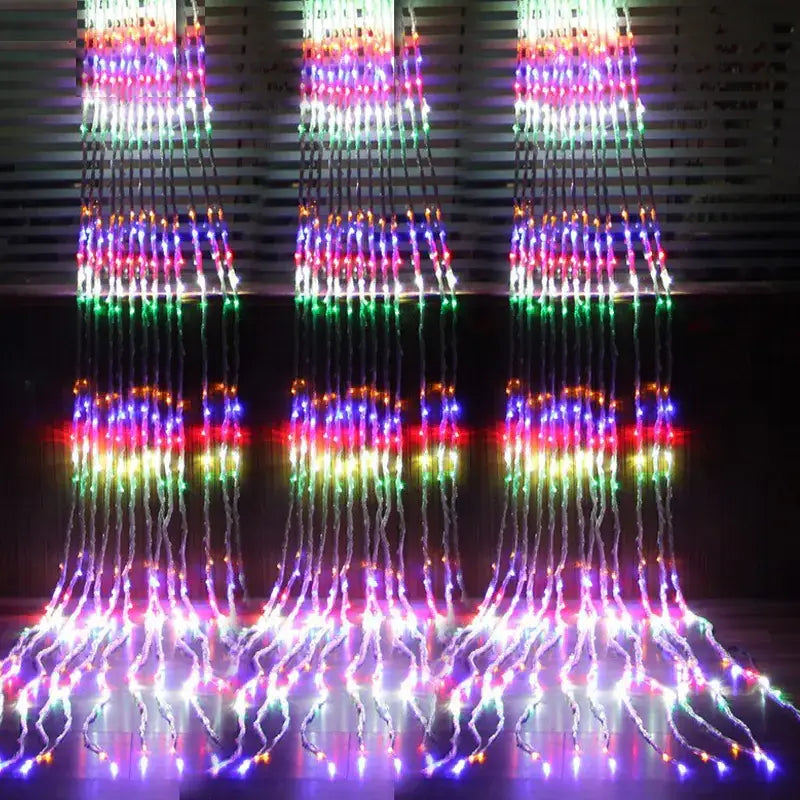 Rainbow-colored led waterfall light display with cascading strands of multicolored bulbs.