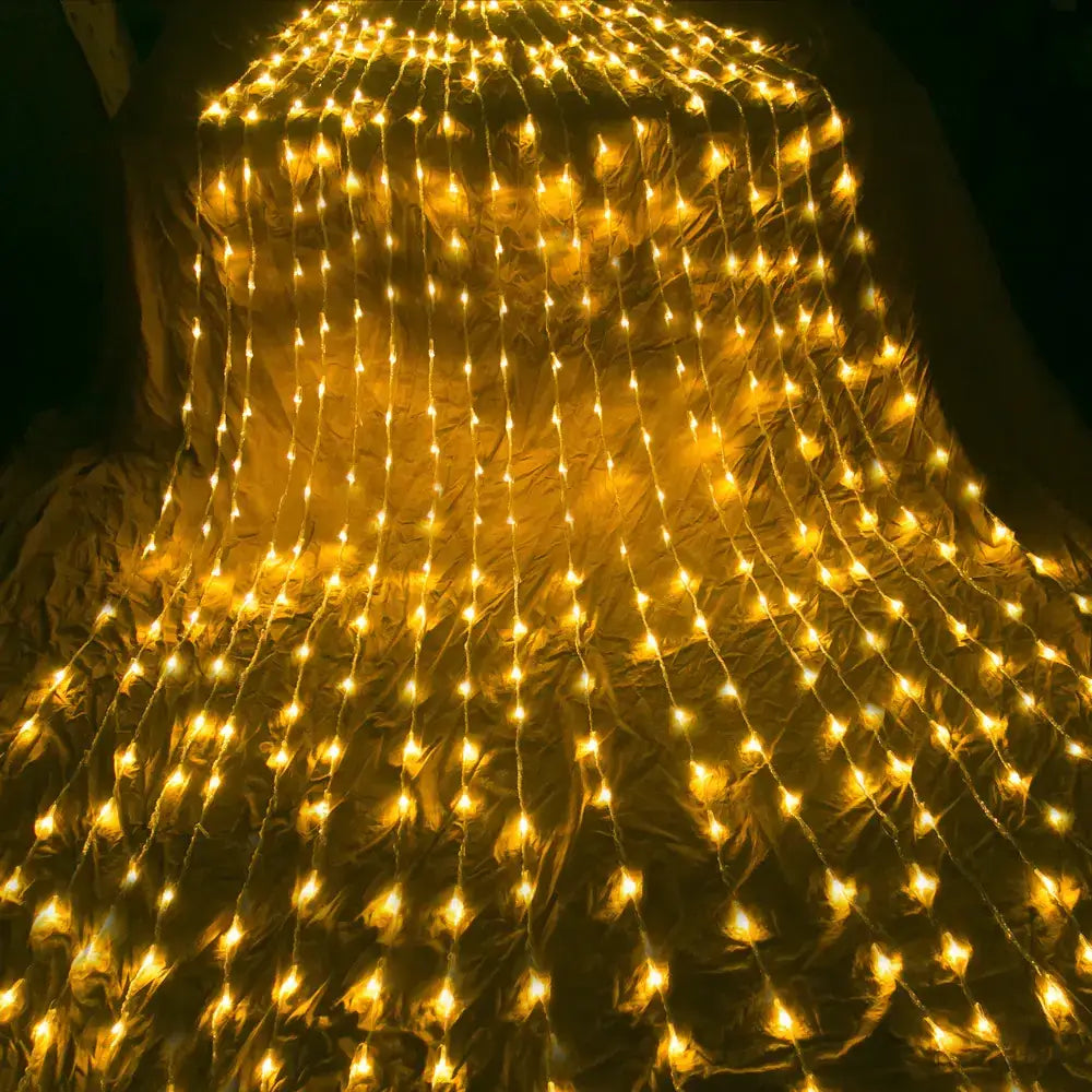 Golden led string lights arranged in a cascading curtain pattern.