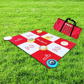 Red and white checkered disc sports disc golf target mat with colorful flying discs scattered across it.
