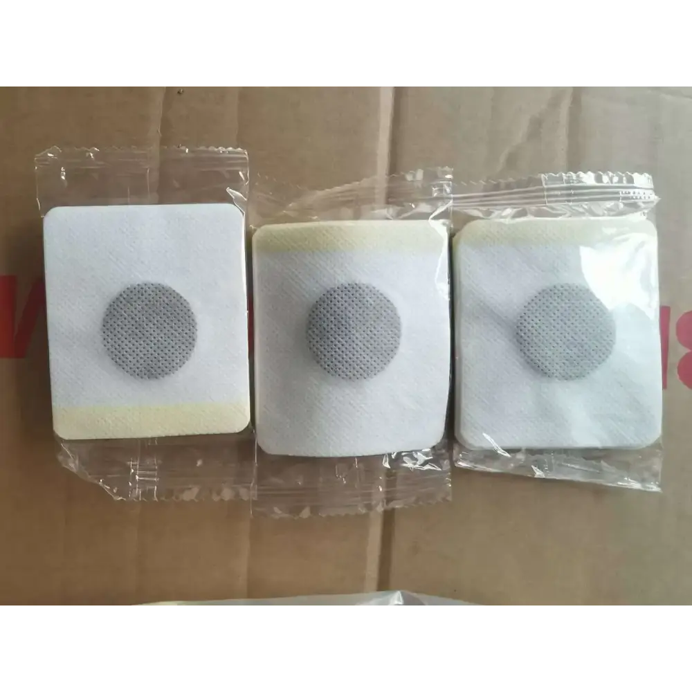 Three individually packaged white square adhesive patches, each featuring a central gray circular mesh area.