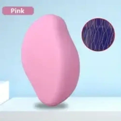 Pink silicone vibrator with a textured, circular surface detail.