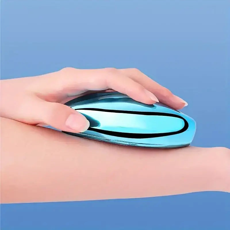 A sleek, light blue metallic device with a black curved accent line is being held gently on an arm.