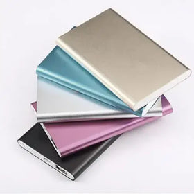 Stack of slim, metallic portable power banks in assorted colors including silver, blue, pink and black.