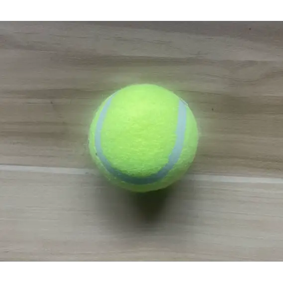 A bright yellow tennis ball with a fuzzy texture and two curved gray lines.